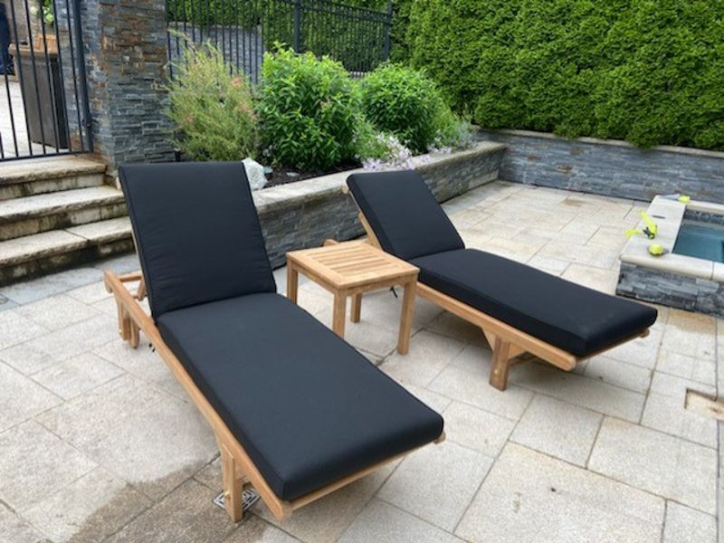 Light teak chaise lounges with navy cushions
